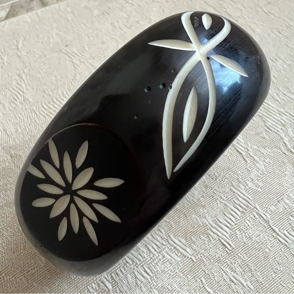 Black/brown bracelet, hand carved to expose ivory color pattern underneath